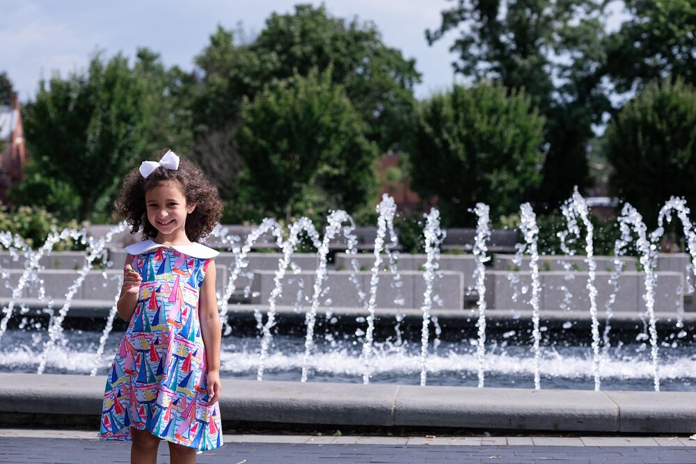 girl in Lily Pulitzer dress poses by Frederick MD fountain
