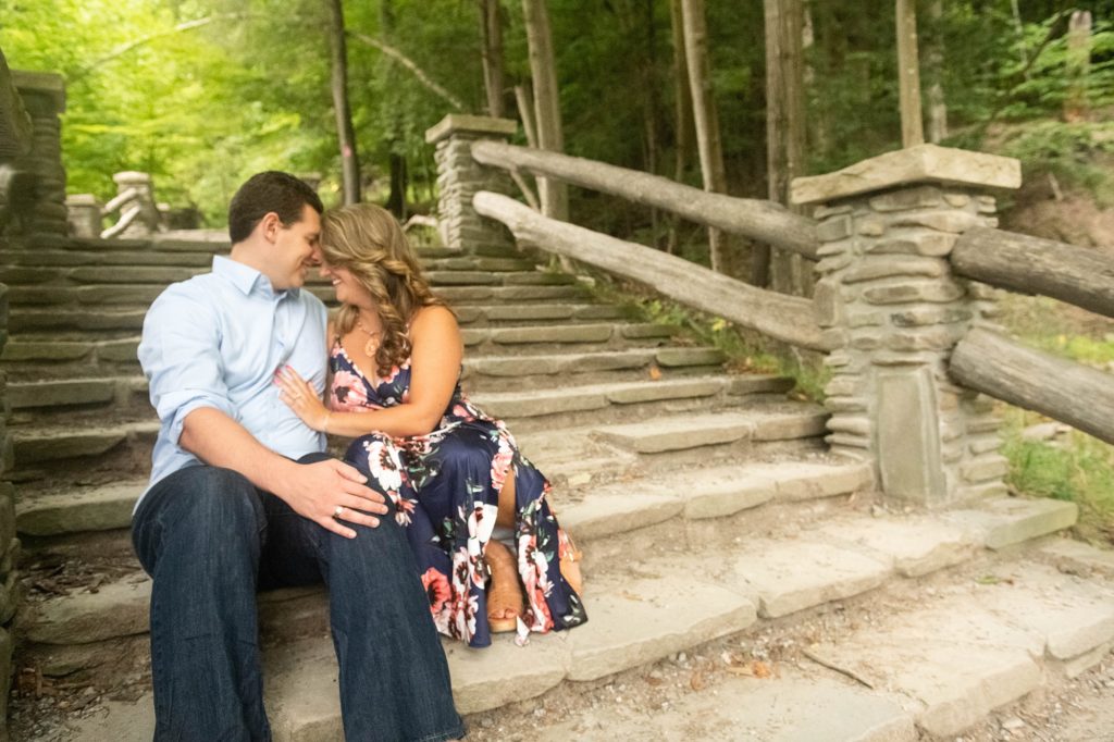 engaged couple sits on staircase in New York park