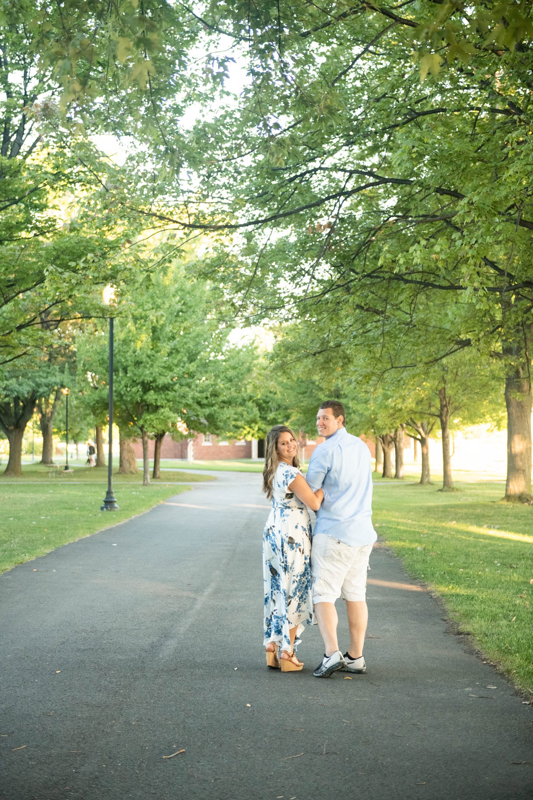couple walks down path in New York during morning engagement photos