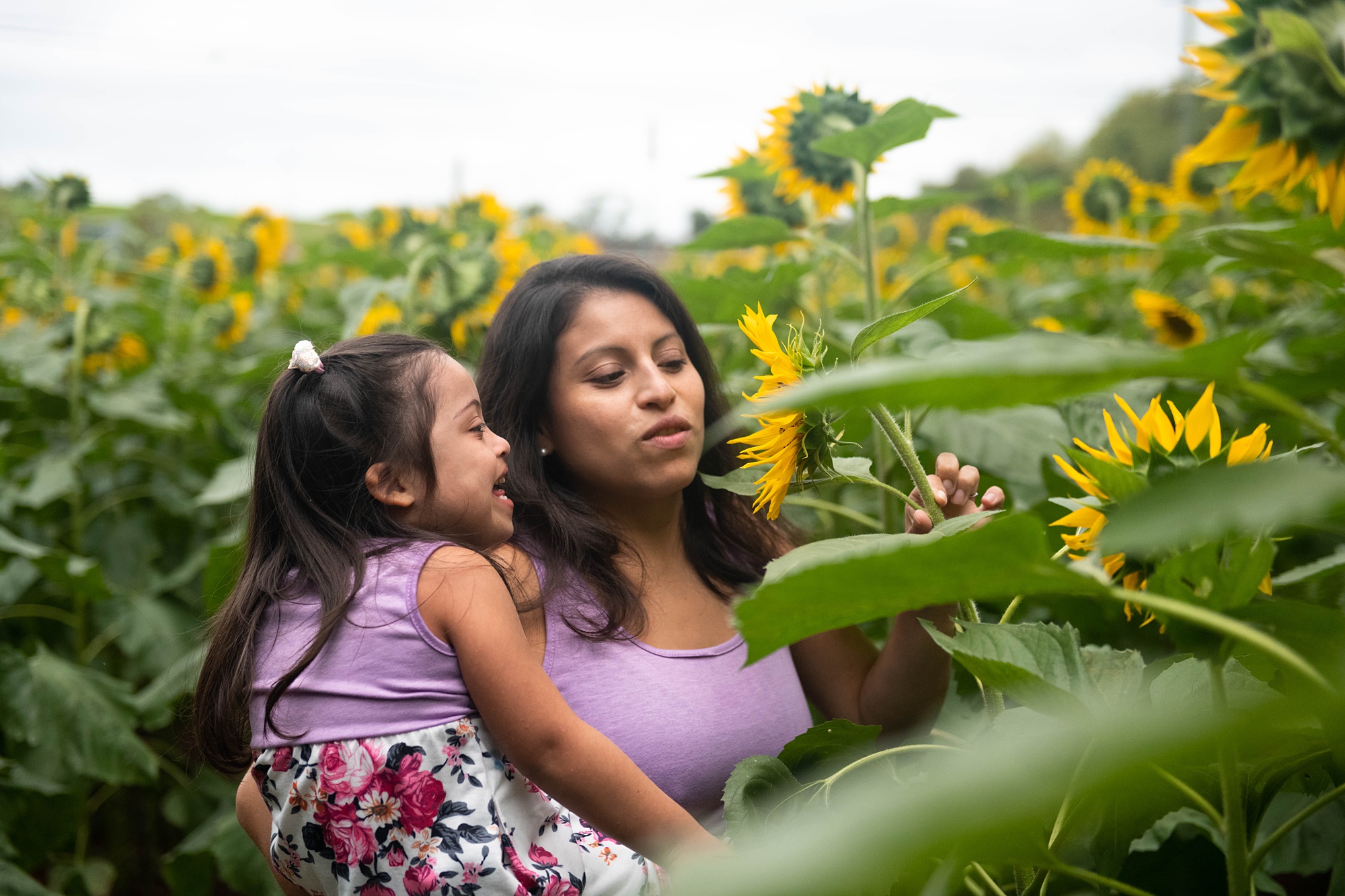 mom shows daughter with Down syndrome sunflower