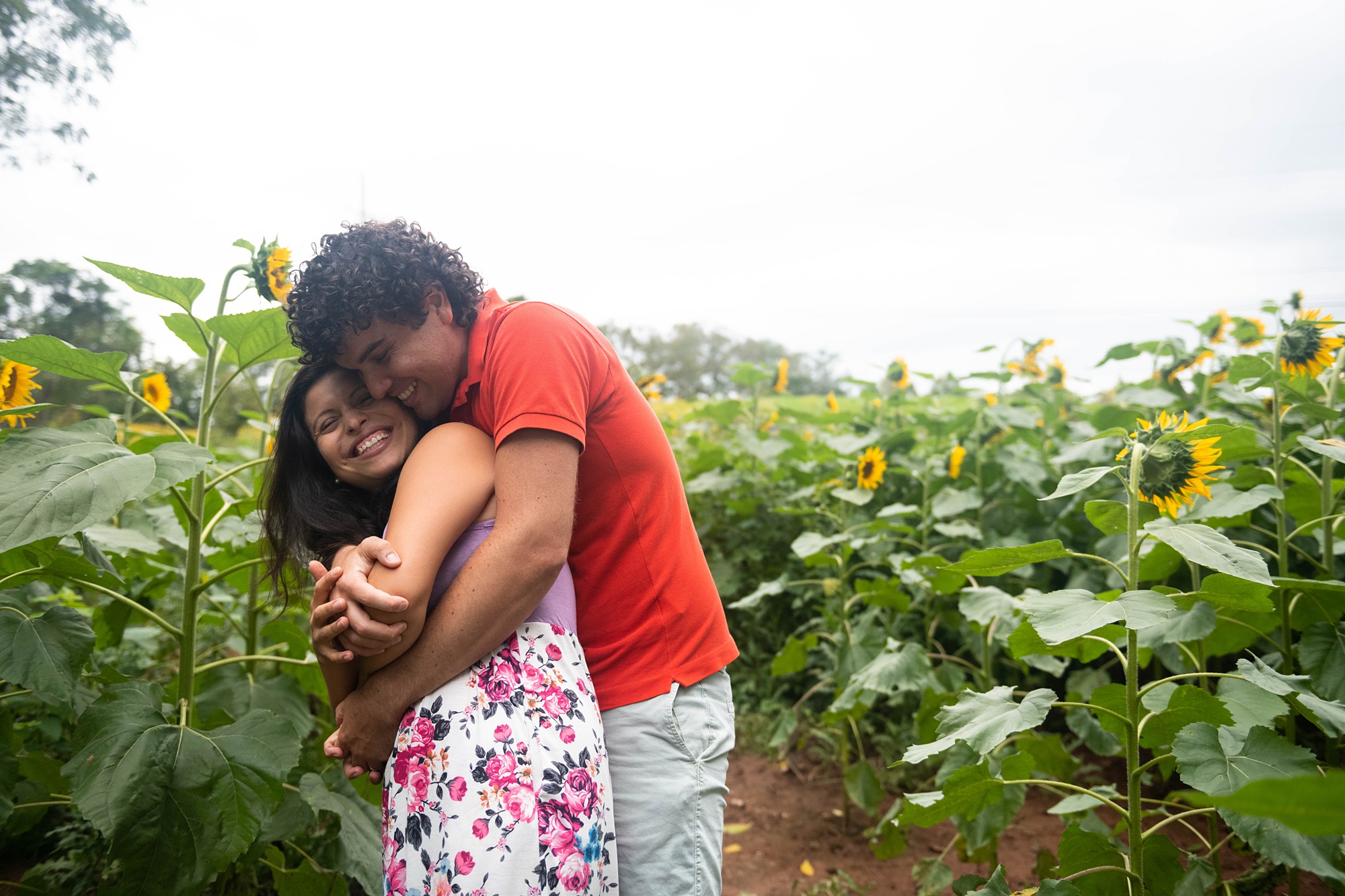 husband hugs wife during Sunflower Photo Session