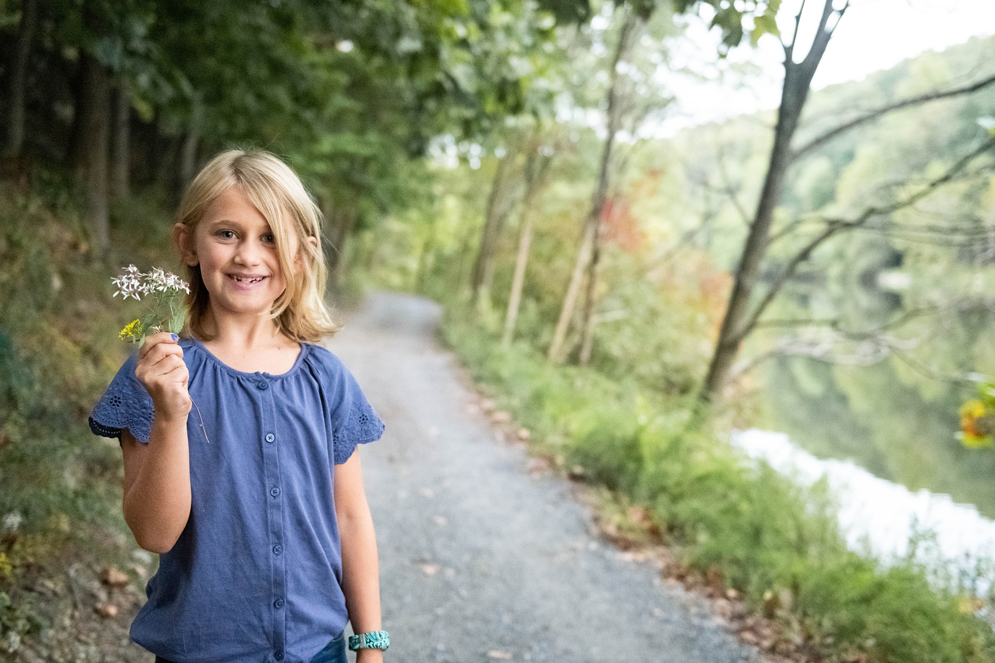 daughter shows off flower in Maryland