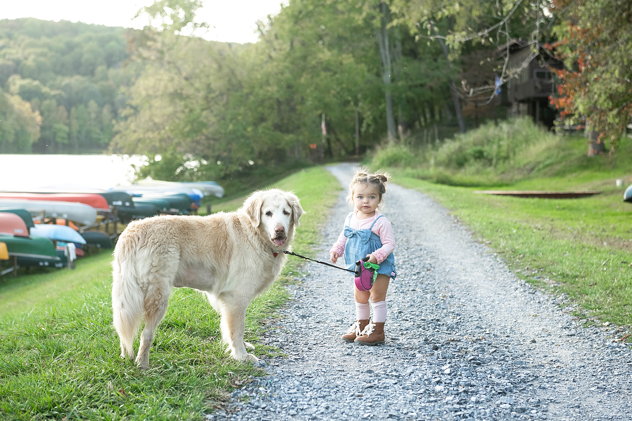 daughter walks dog during family photos in Lake Linganore