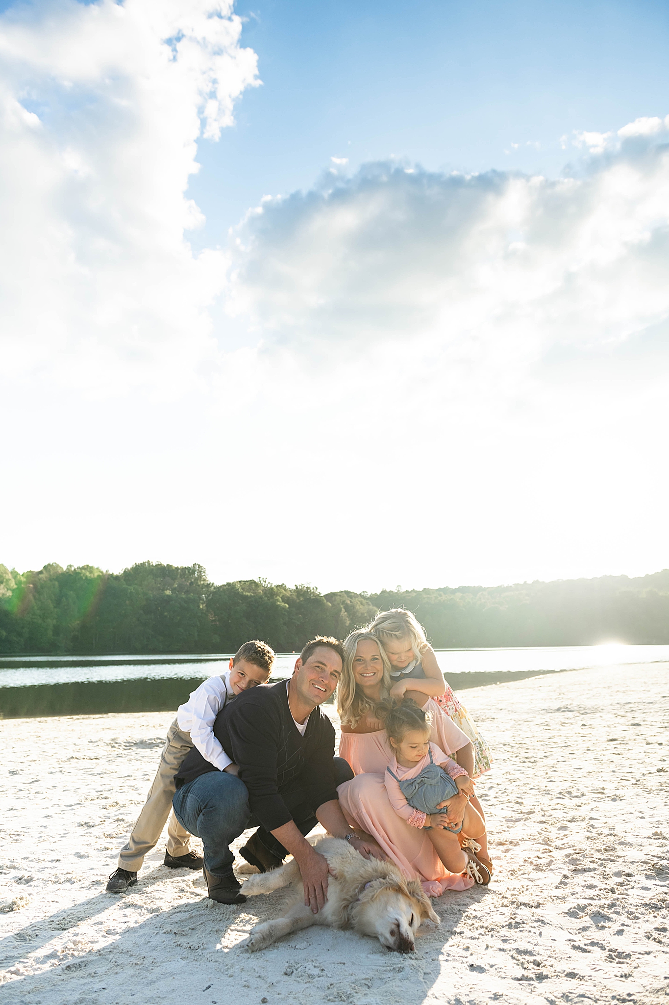 family of five poses on Lake Linganore