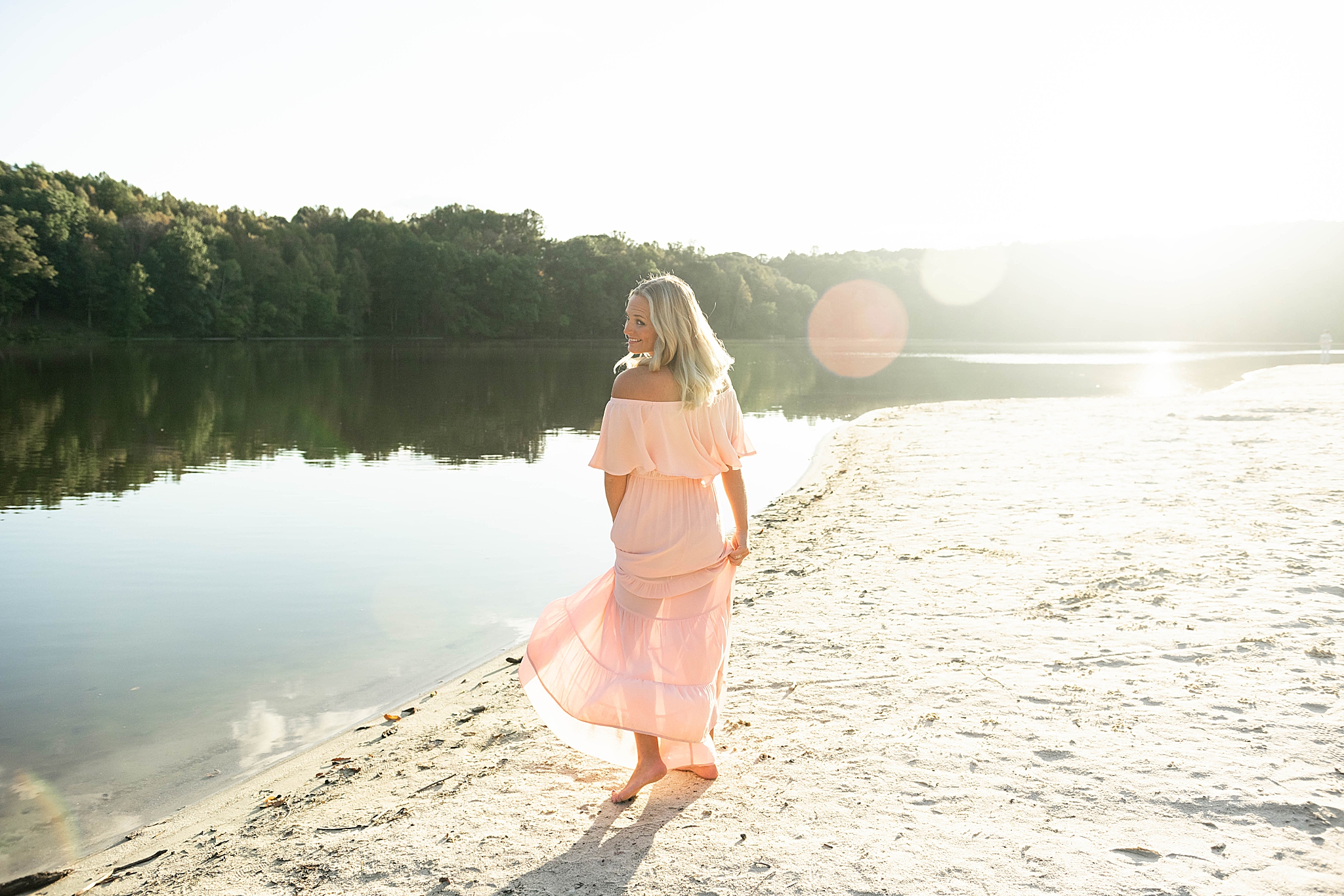mom twirls pastel pink dress during Lake Linganore family photos