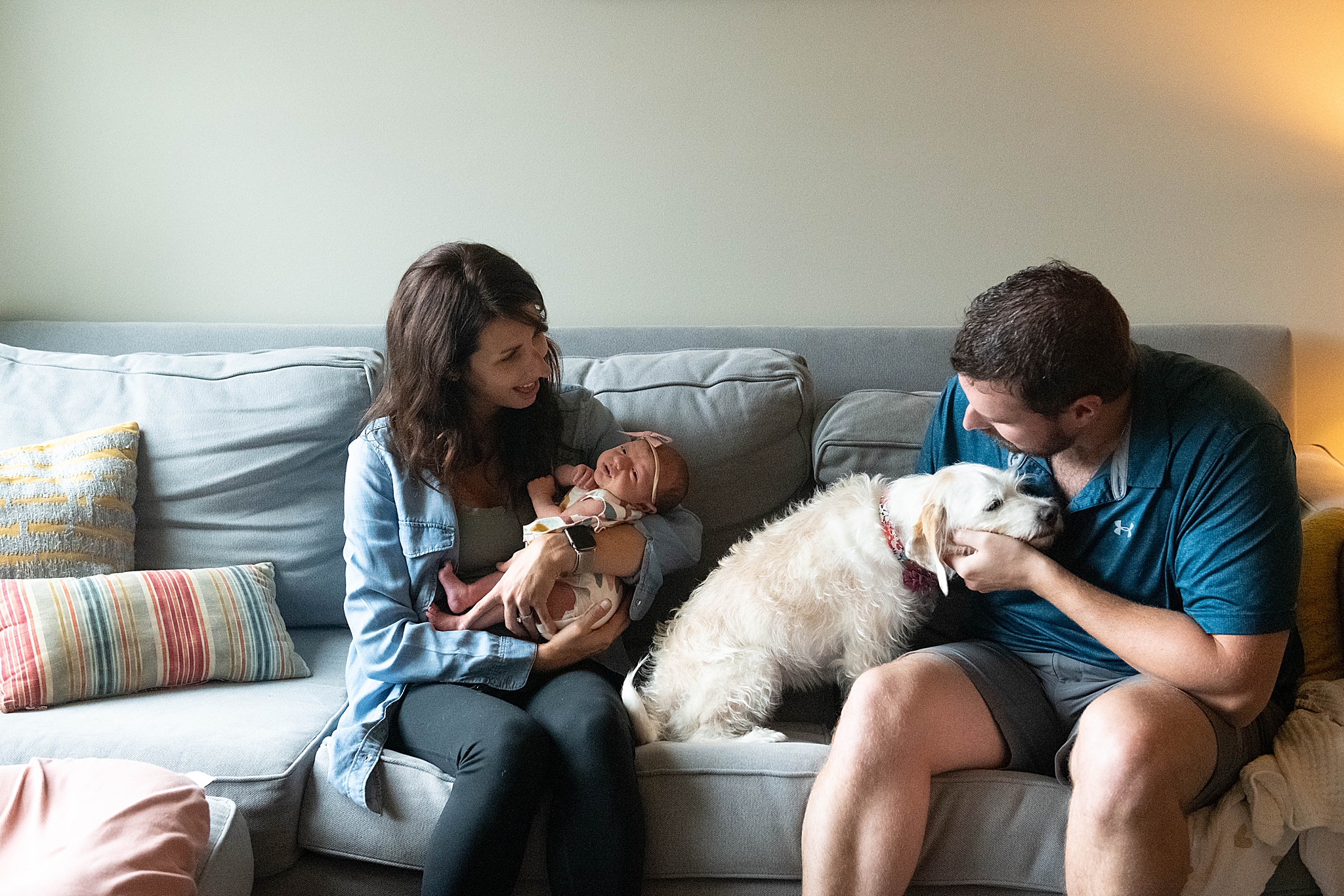 family plays on couch with newborn baby girl during Washington DC Lifestyle Newborn session