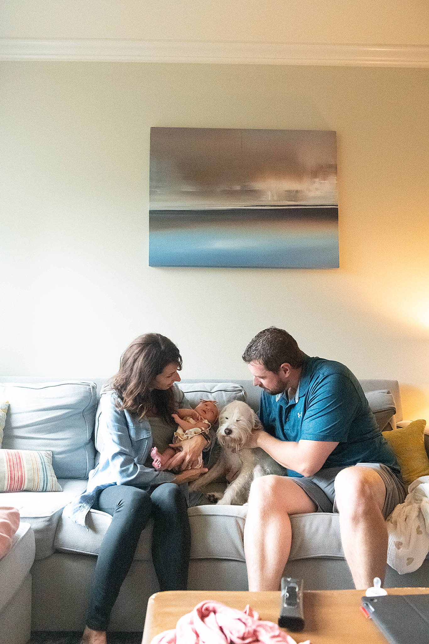 parents look at baby girl and dog during Washington DC Lifestyle Newborn session