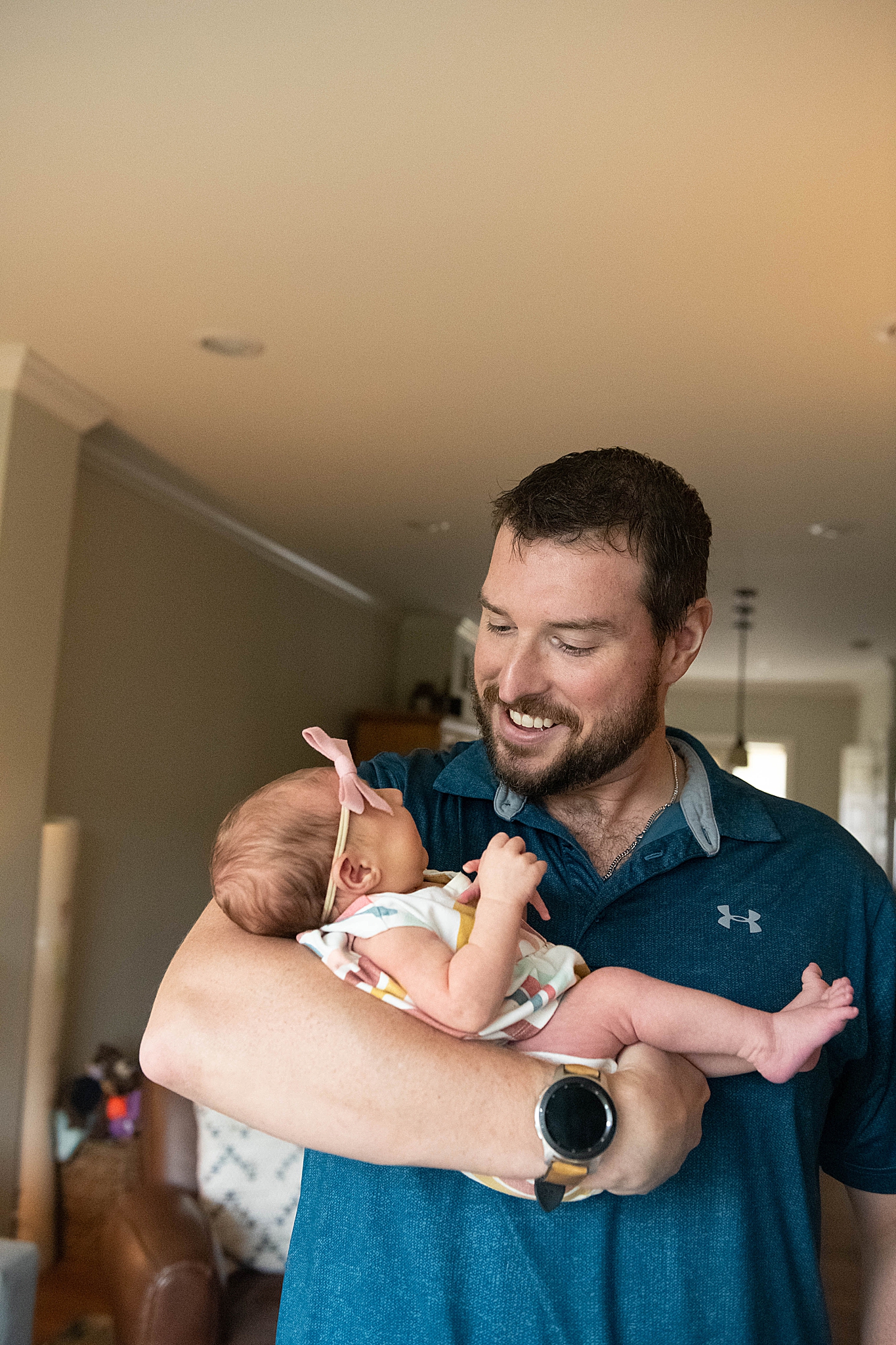 dad holds baby girl during Washington DC Lifestyle Newborn session