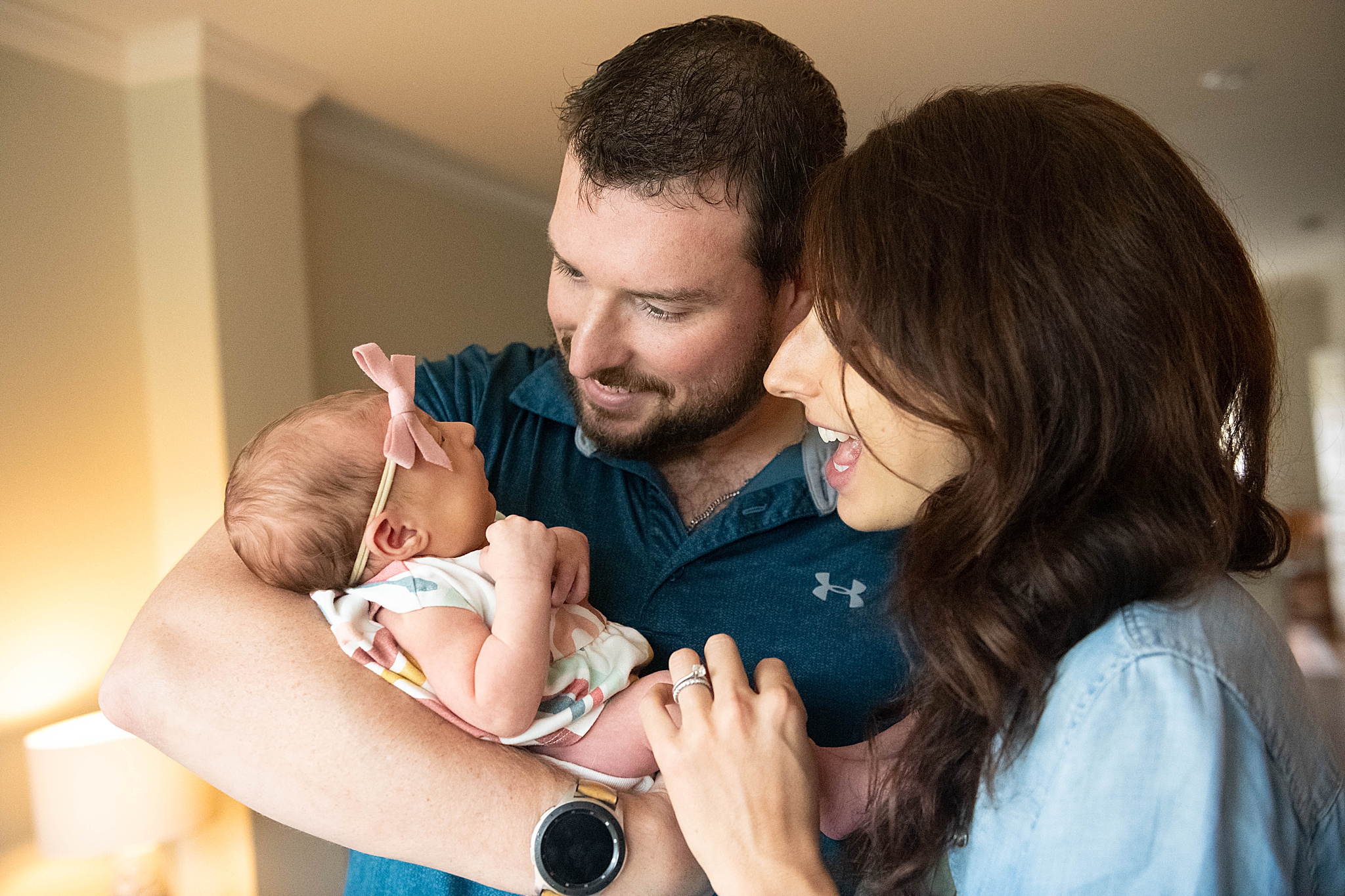 parents laugh with baby during in-home lifestyle newborn session