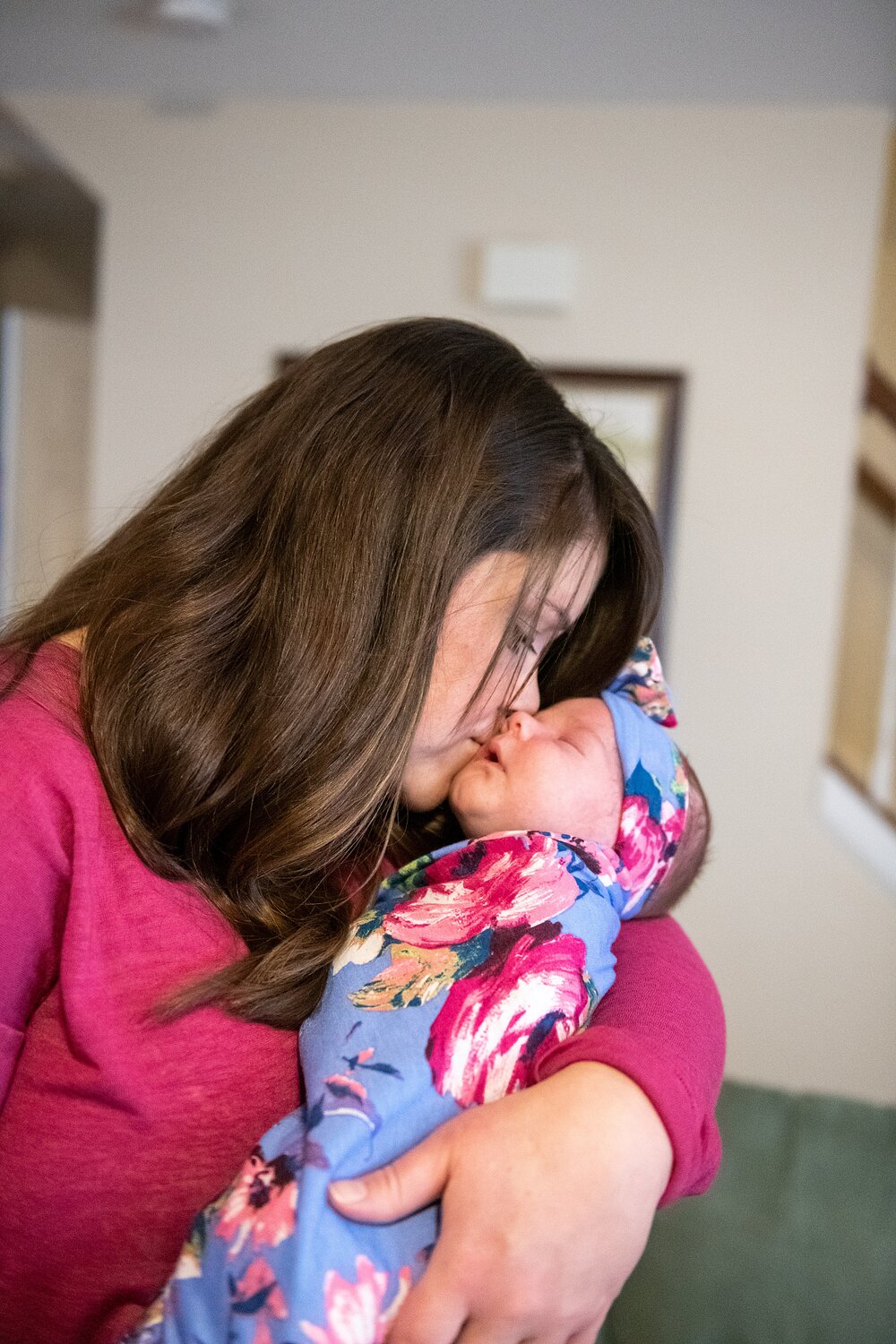 mom snuggles with baby during lifestyle newborn session
