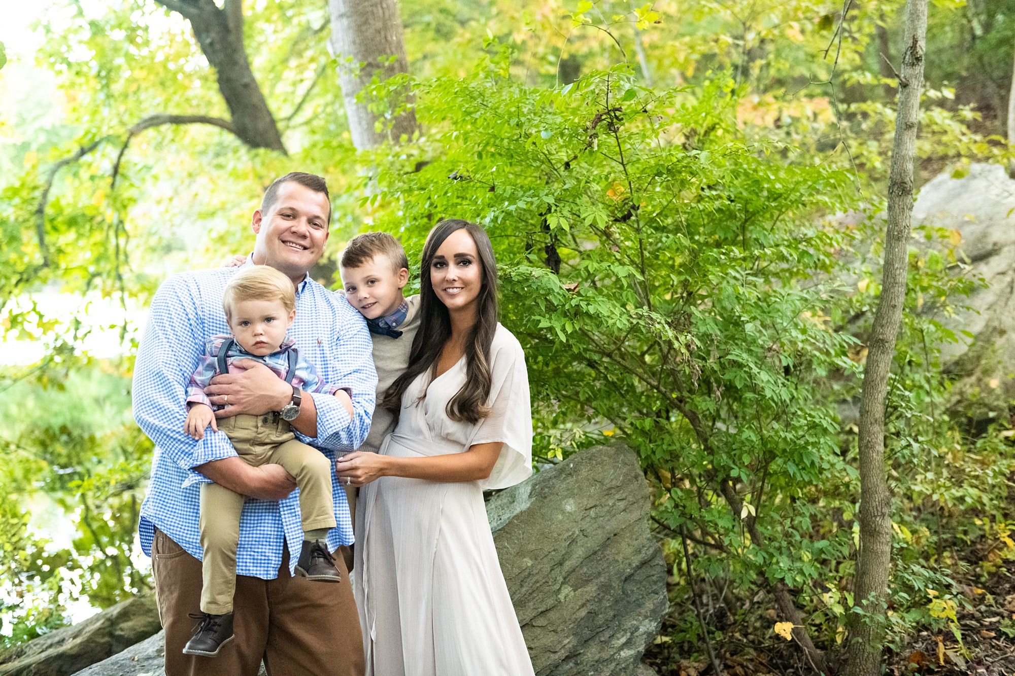 family poses by tree during Frederick County family portraits