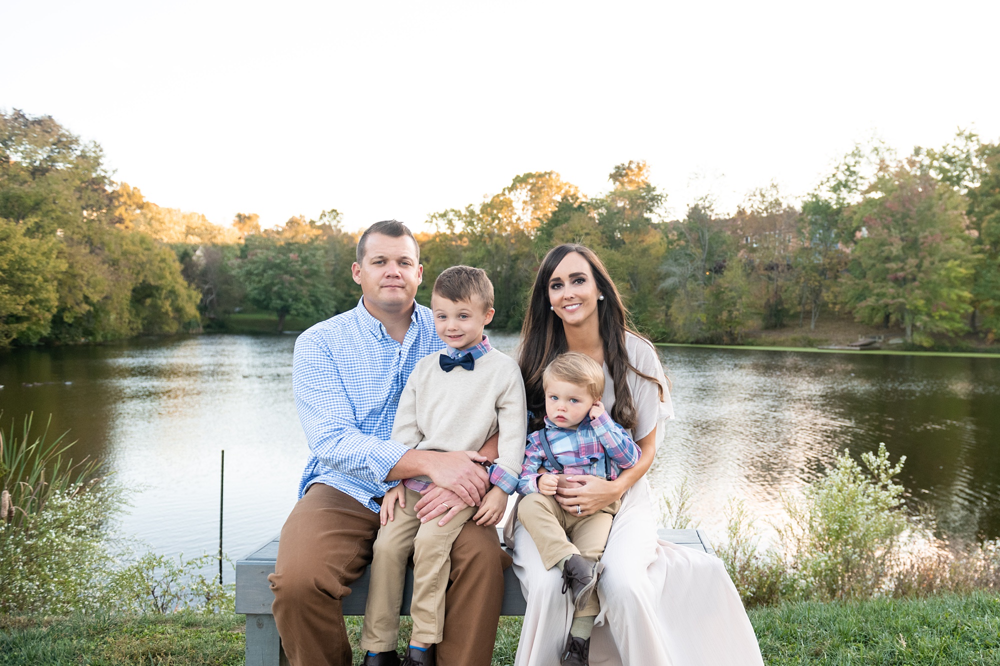 family of four poses along waterfront in Frederick County