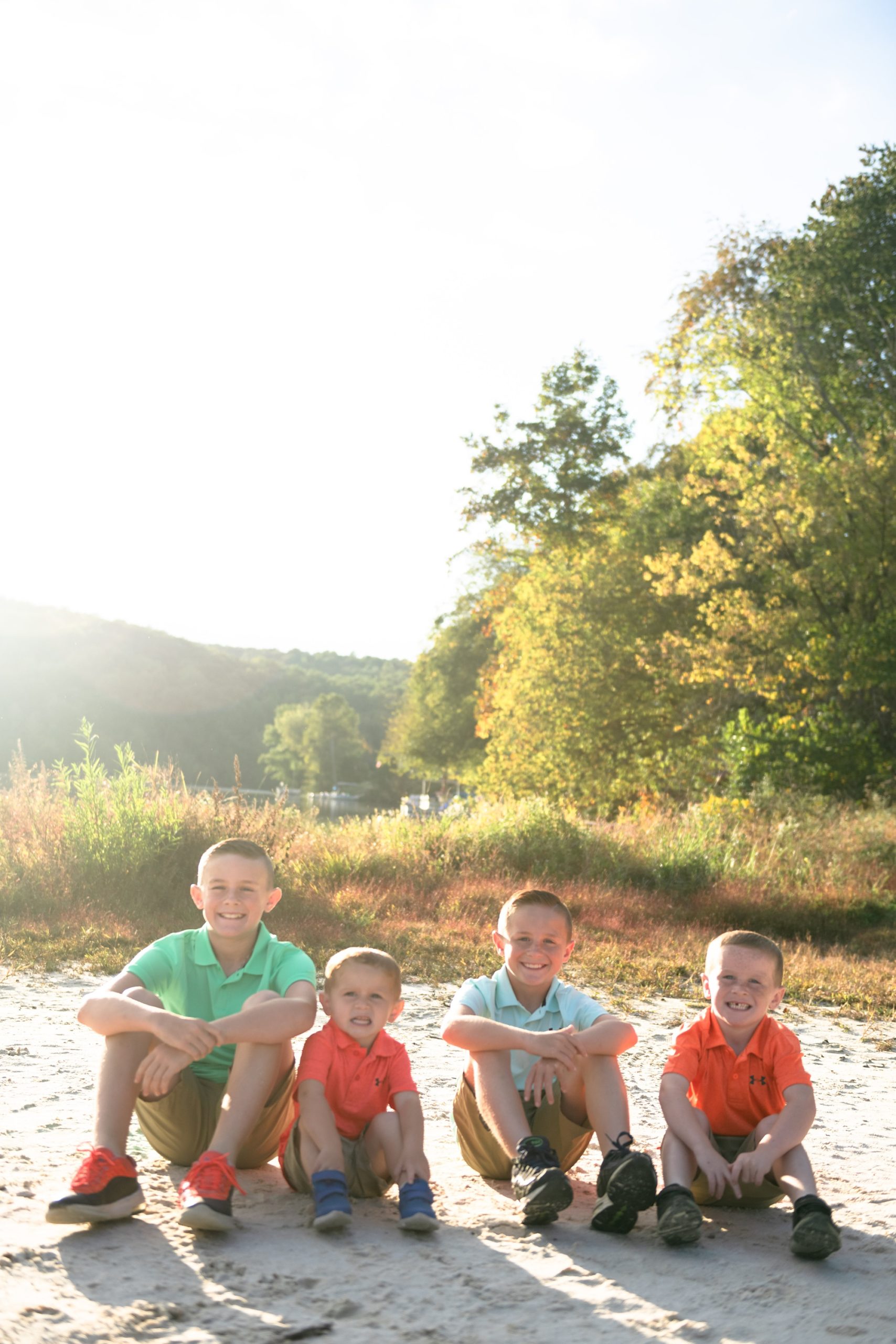 four boys sit together by Lake Lingnore