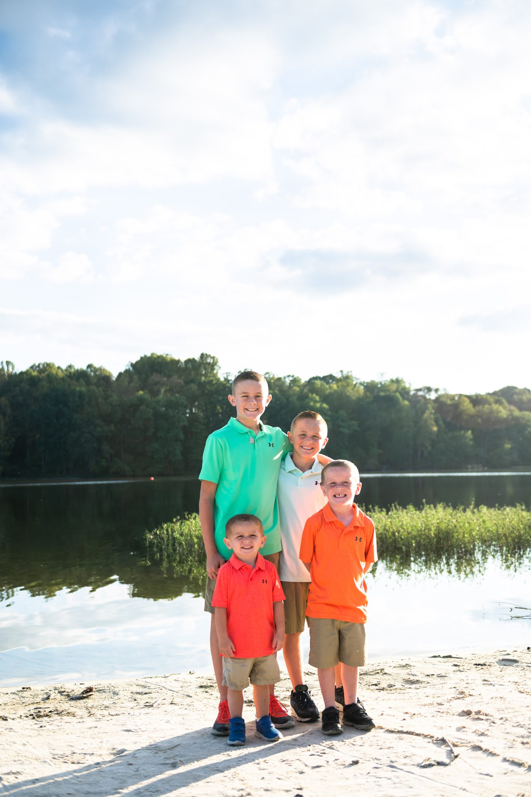 brothers pose together by lakefront during Lake Linganore family session