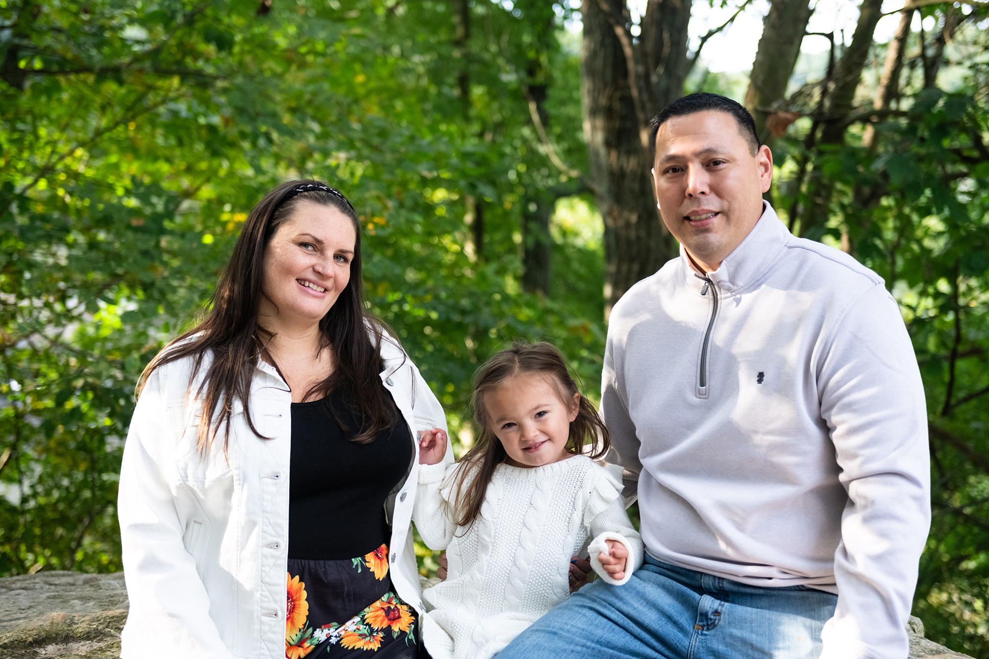 parents sit with daughter during Lake Linganore family portraits