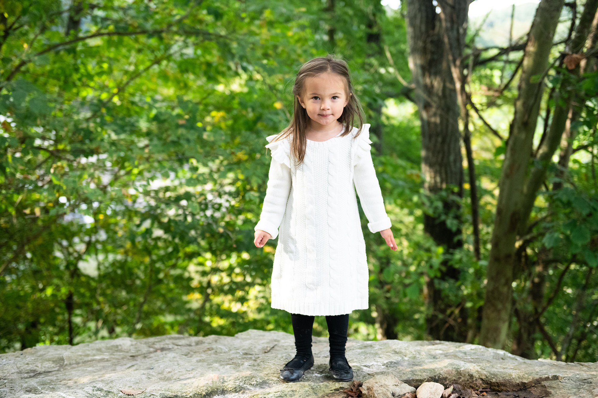 toddler climbs rocks during Frederick MD family session