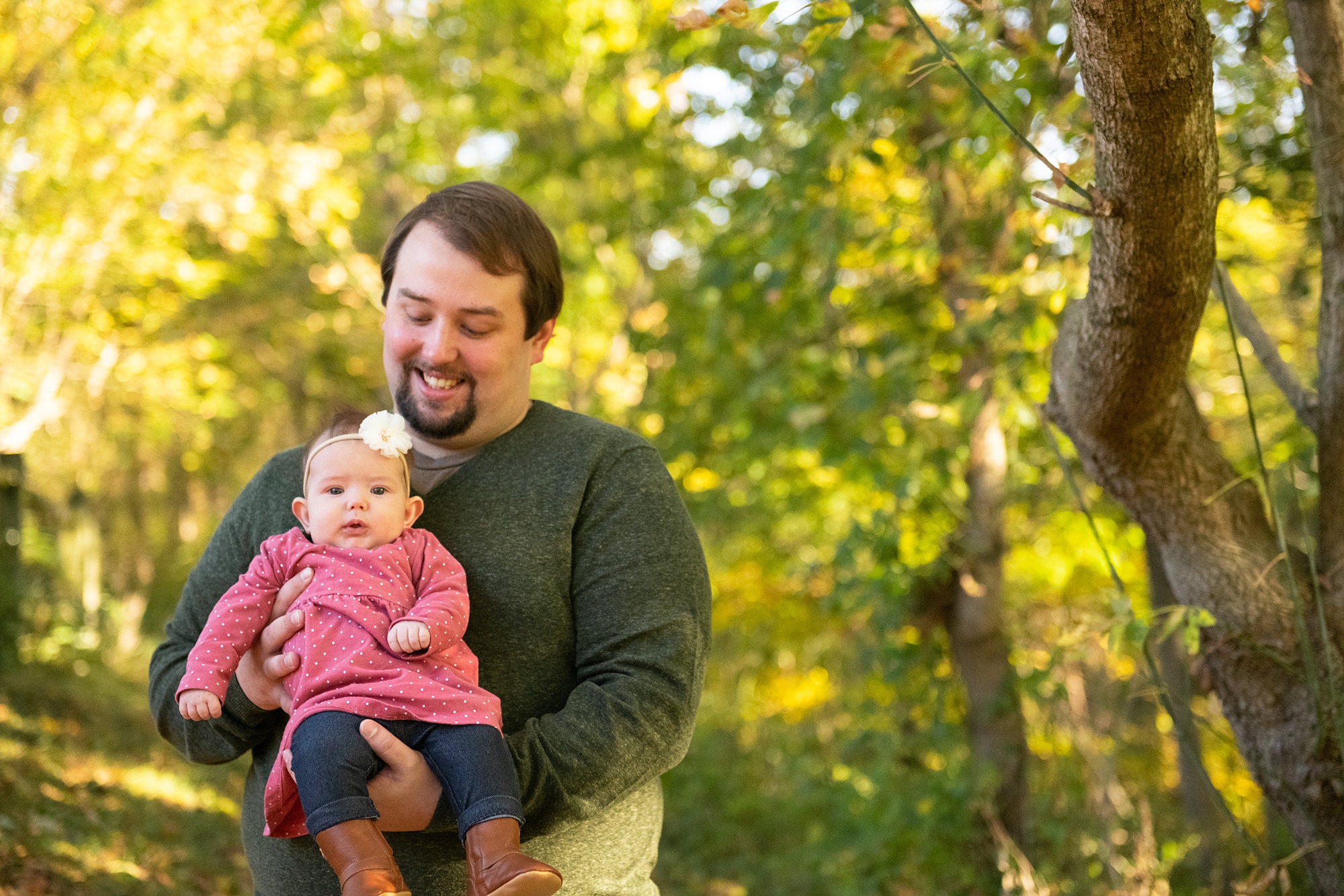dad holds new baby girl during Frederick County family portraits