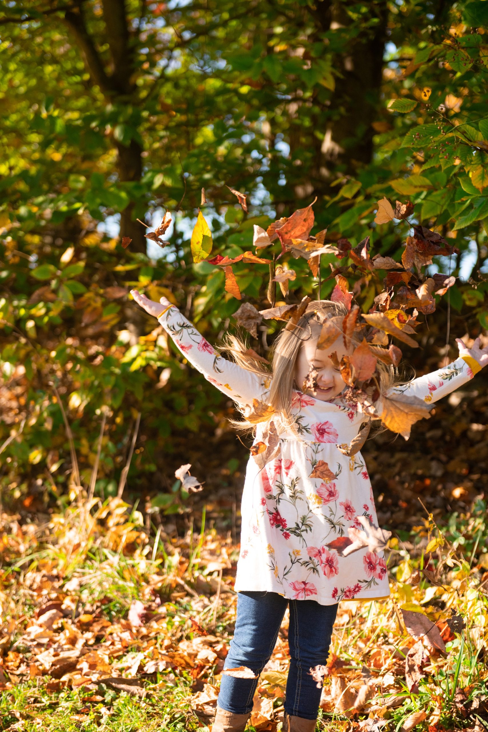 toddler throws leaves during Frederick County family portraits