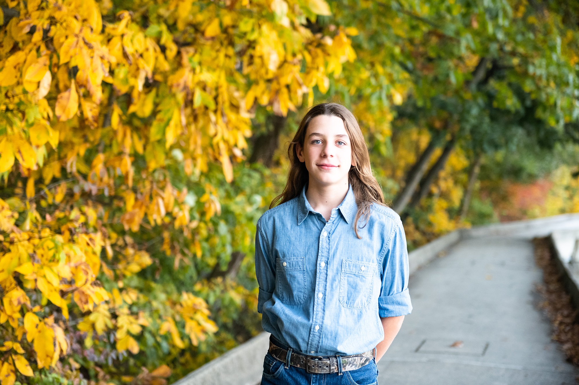 son poses in front of fall foliage in Frederick MD