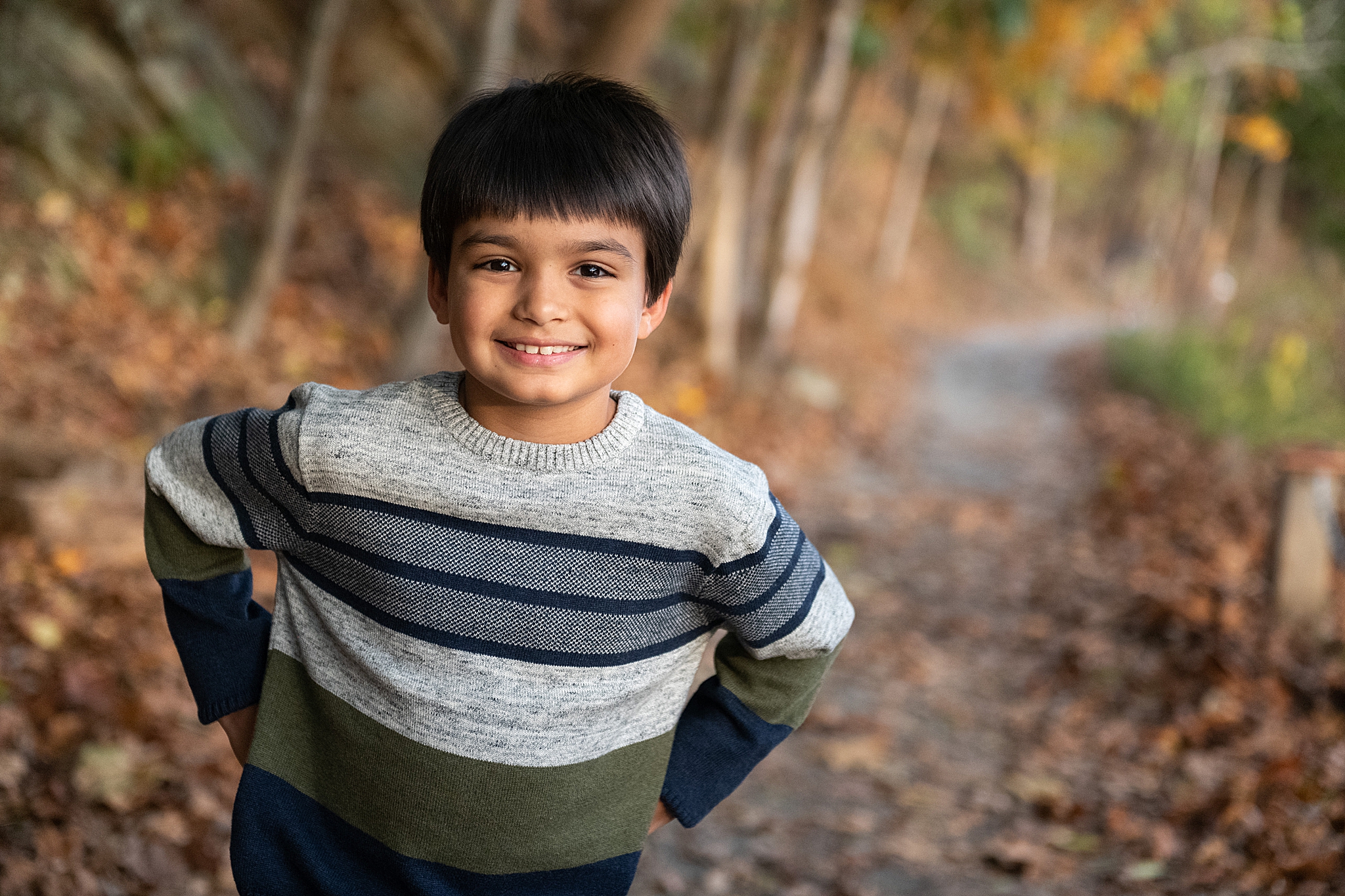toddler plays in striped sweater during Lake Linganore family photo session