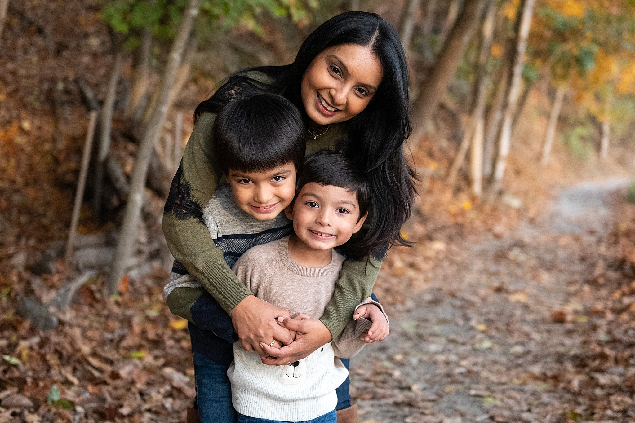 mom and two boys hug during Lake Linganore family photo session