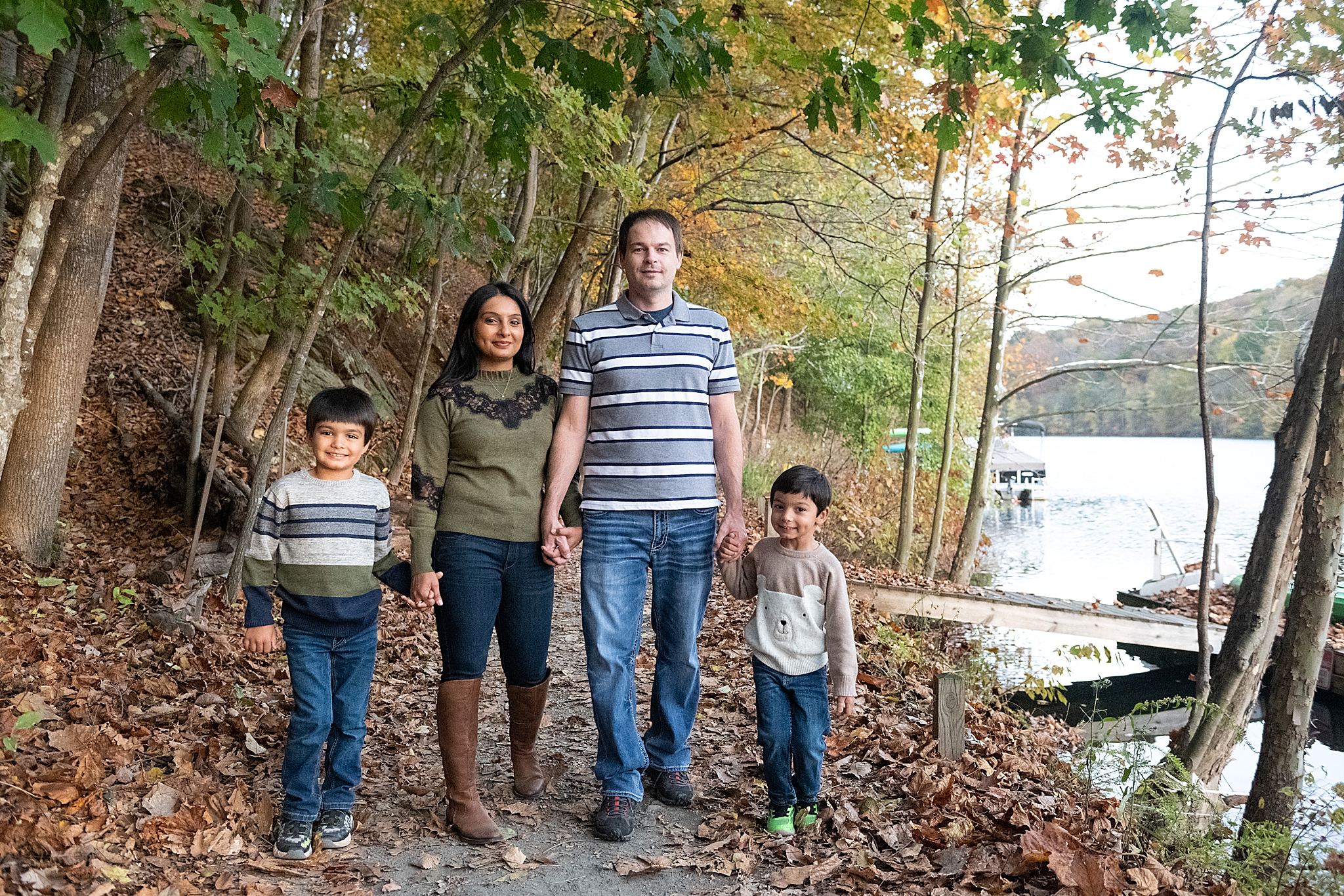 family of four walks along pathway in Lake Linganore