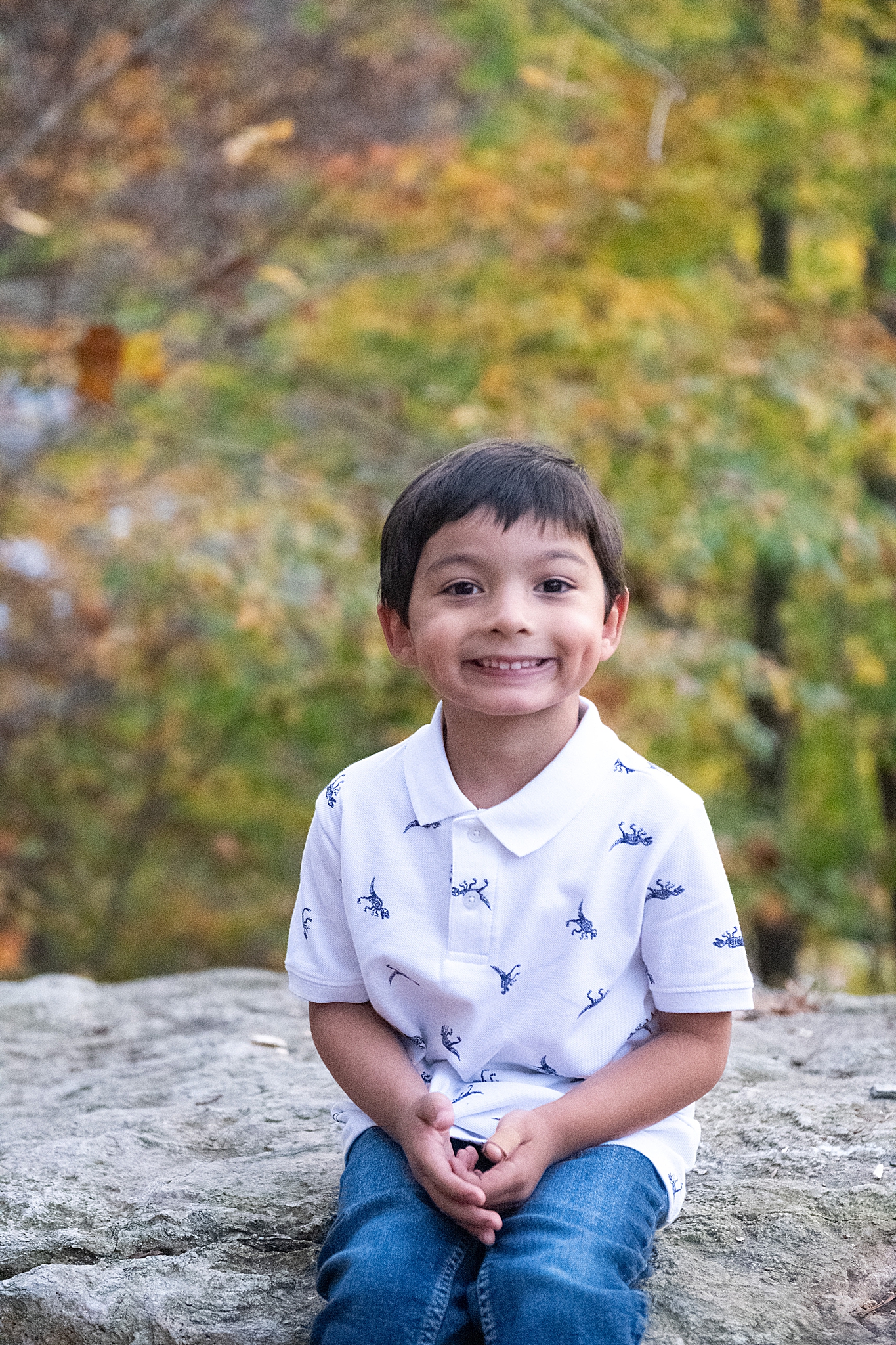 toddler in white polo poses during MD family photos
