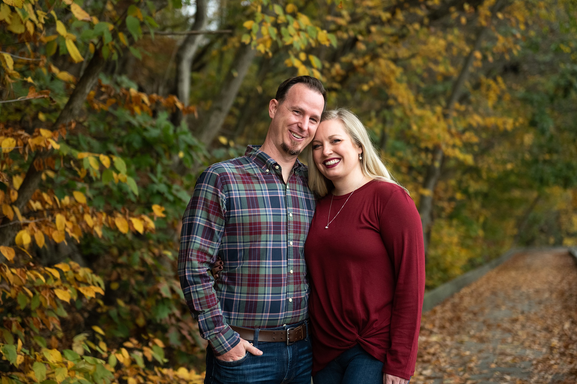 husband and wife pose together during fall 