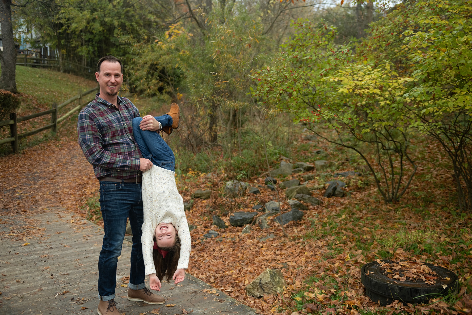 dad turns daughter upside down during MD family photos