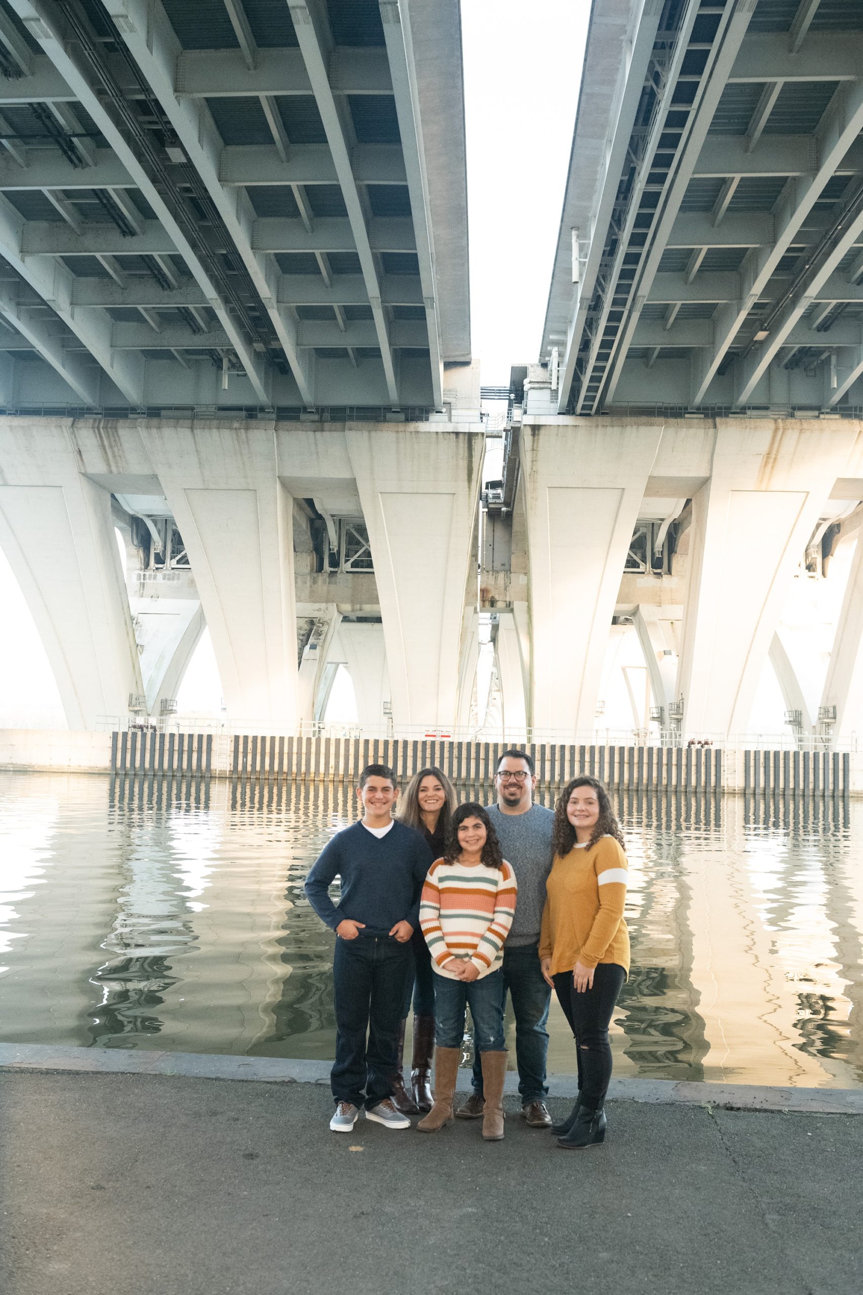 Riverfront Family Portraits in Alexandria under bridge